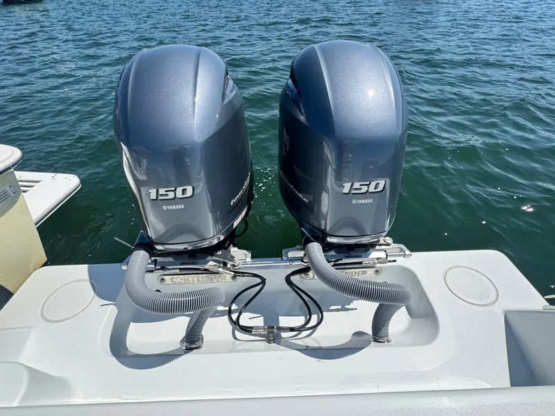 Slide: The Image of Two Yamaha 150 outboard engines are mounted on the stern of a Contender 24 Sport boat. - 10