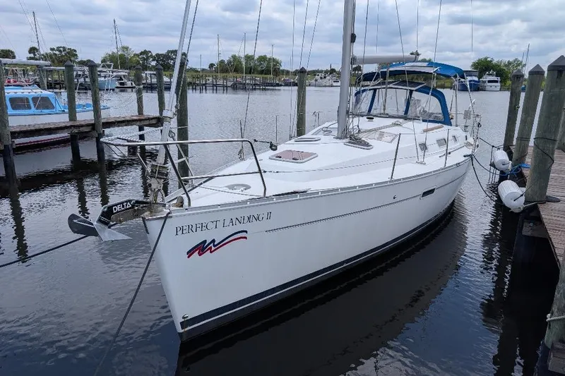 Slide: The Image of 2006 Beneteau Oceanis 352 sailboat docked at marina, named "Perfect Landing II". - 2