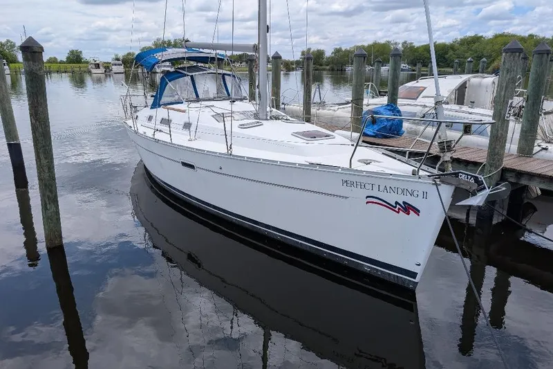 Slide: The Image of 2006 Beneteau Oceanis 352 sailboat docked at marina, calm water reflections. - 0