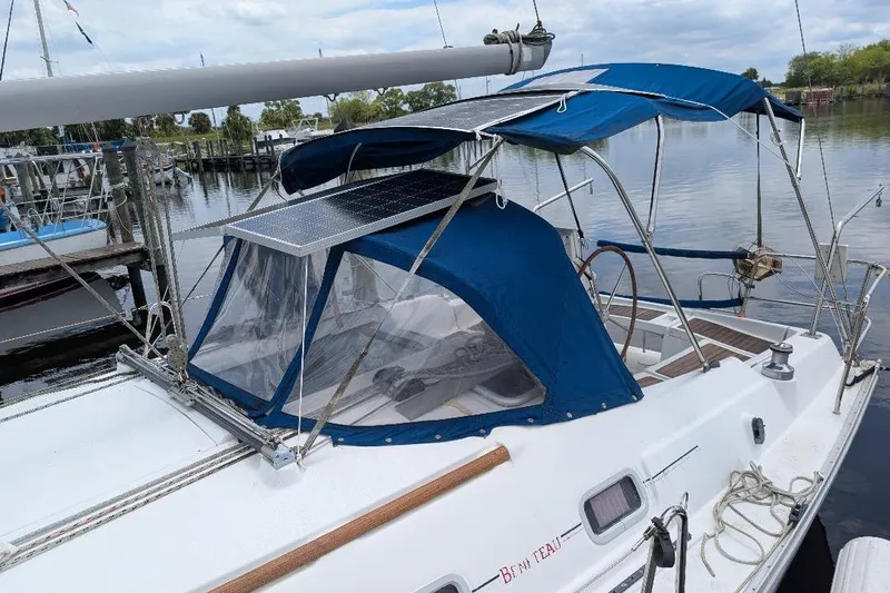 Slide: The Image of 2006 Beneteau Oceanis 352 sailboat with blue canopy and solar panel at marina. - 4