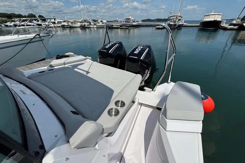 Slide: The Image of 2025 Axopar 29 XC Cross Cabin boat docked with twin outboard engines. - 15