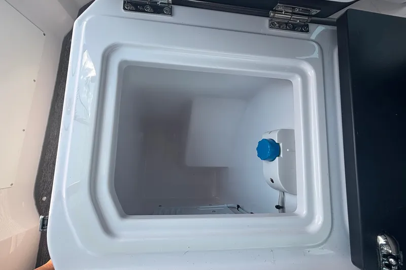 Slide: The Image of Open storage compartment inside 2025 Axopar 29 XC Cross Cabin boat. - 35