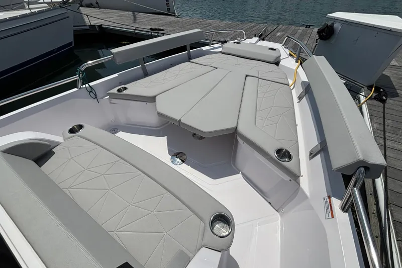 Slide: The Image of 2025 Axopar 29 XC Cross Cabin boat with spacious seating and modern design at the dock. - 13