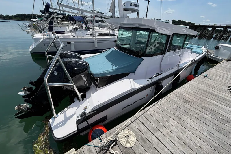 Slide: The Image of 2025 Axopar 29 XC Cross Cabin docked, featuring sleek design and powerful outboard engines. - 6