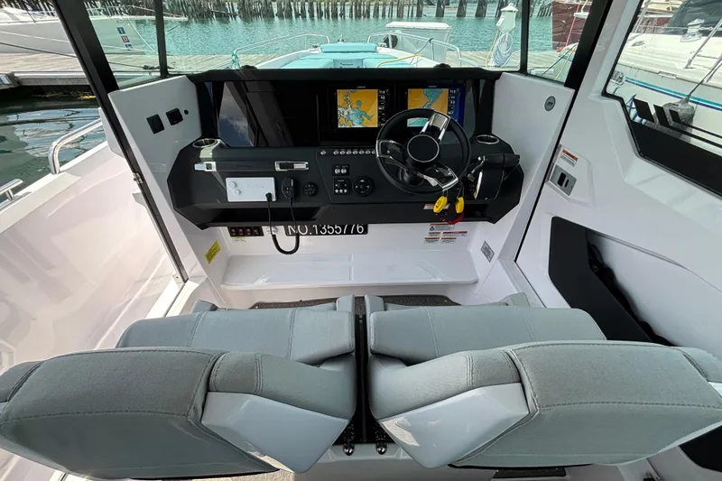 Slide: The Image of Interior view of 2025 Axopar 29 XC Cross Cabin with modern dashboard and dual seats. - 10