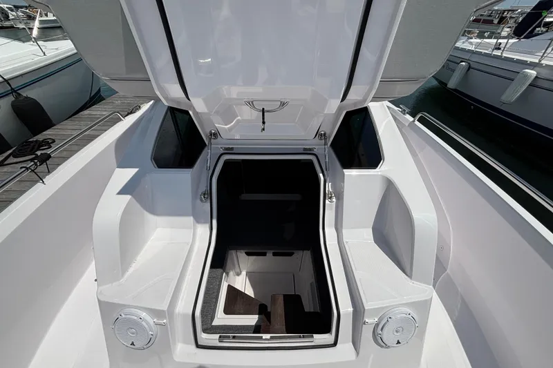 Slide: The Image of 2025 Axopar 29 XC Cross Cabin boat interior entrance with open hatch. - 22