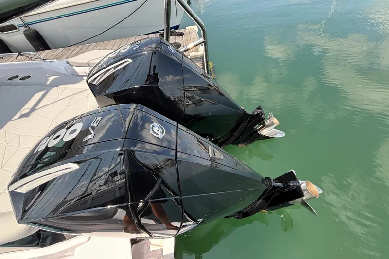 Slide: The Image of Twin outboard engines on 2025 Axopar 29 XC Cross Cabin, docked in calm water. - 32