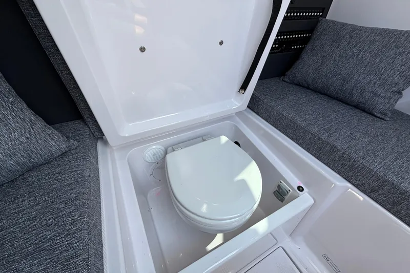 Slide: The Image of 2025 Axopar 29 XC Cross Cabin interior with hidden toilet under seat. - 25