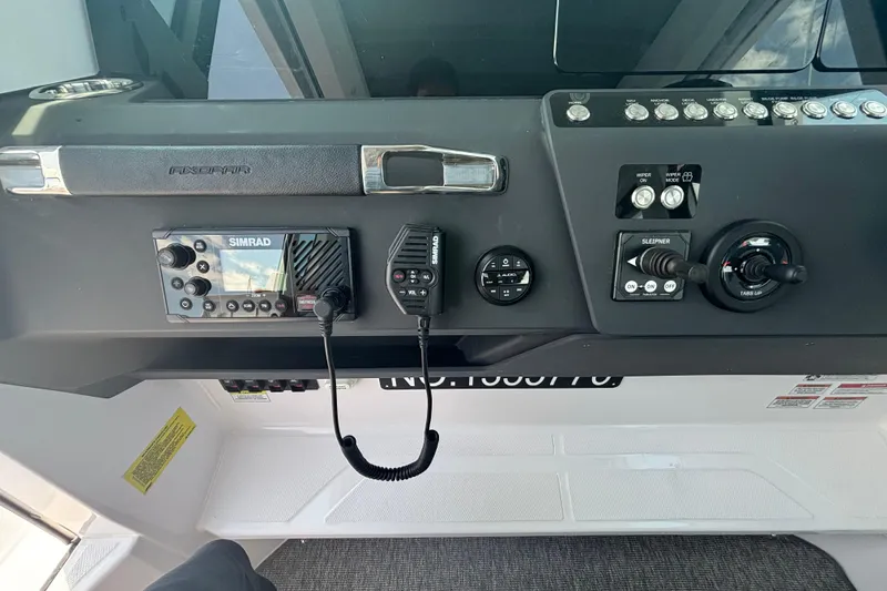 Slide: The Image of Control panel of 2025 Axopar 29 XC Cross Cabin with Simrad navigation system. - 27