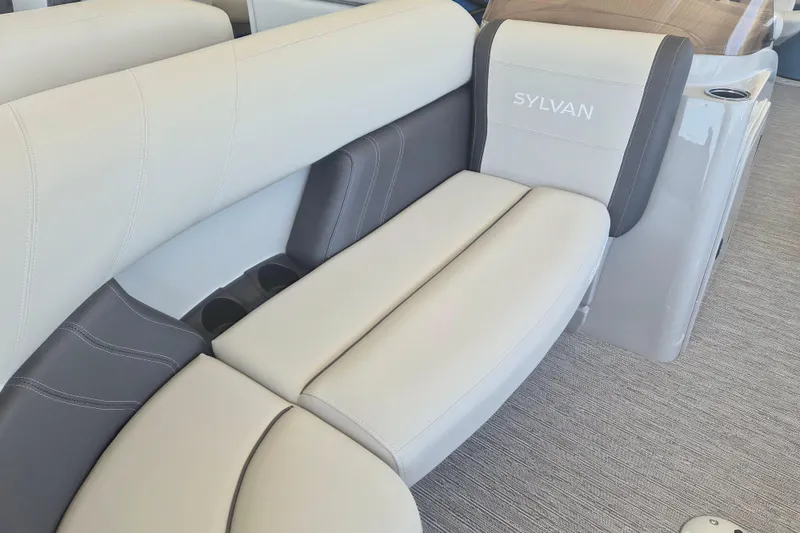 Slide: The Image of 2026 Sylvan Mirage Fish 820 Party Fish boat interior with plush seating and cup holders. - 3