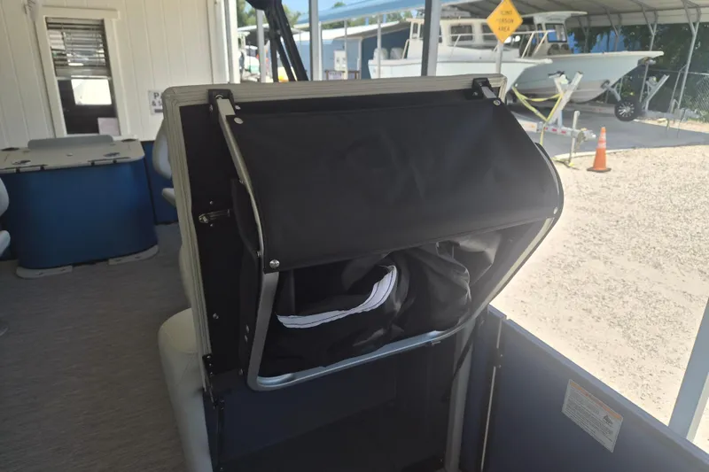 Slide: The Image of 2026 Sylvan Mirage Fish 820 Party Fish boat interior with storage compartment open. - 7