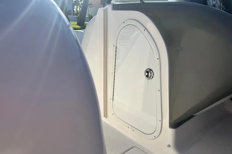 Slide: The Image of 2009 Regal 2400 Bowrider boat interior with sunlight highlighting storage compartment. - 36
