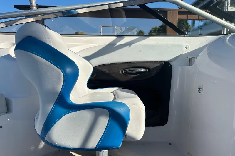 Slide: The Image of Interior of a 2009 Regal 2400 Bowrider boat with blue and white seating. - 55