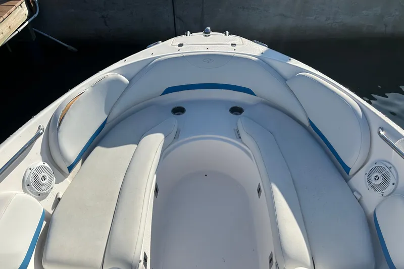 Slide: The Image of 2009 Regal 2400 Bowrider boat interior with white seating and blue accents. - 39