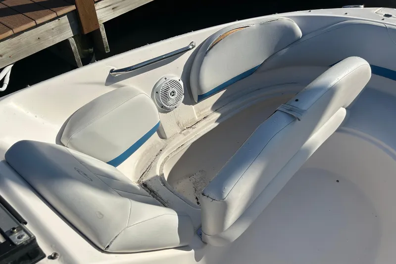 Slide: The Image of 2009 Regal 2400 Bowrider boat interior with white seating and speaker. - 45