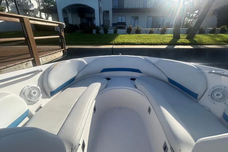 Slide: The Image of 2009 Regal 2400 Bowrider boat interior with white seating and blue accents. - 38