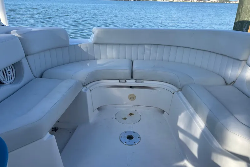 Slide: The Image of 2009 Regal 2400 Bowrider boat interior with white seating, overlooking calm water. - 62