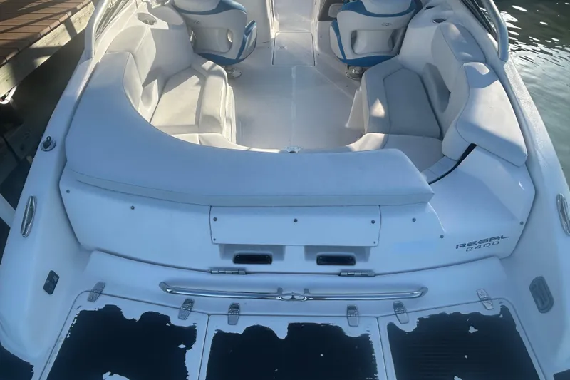 Slide: The Image of 2009 Regal 2400 Bowrider boat interior with white seating and blue accents. - 14
