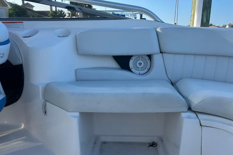 Slide: The Image of 2009 Regal 2400 Bowrider interior with white seating and built-in speaker. - 60