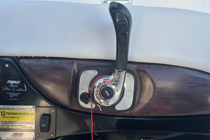 Slide: The Image of Throttle control on a 2009 Regal 2400 Bowrider boat dashboard. - 26
