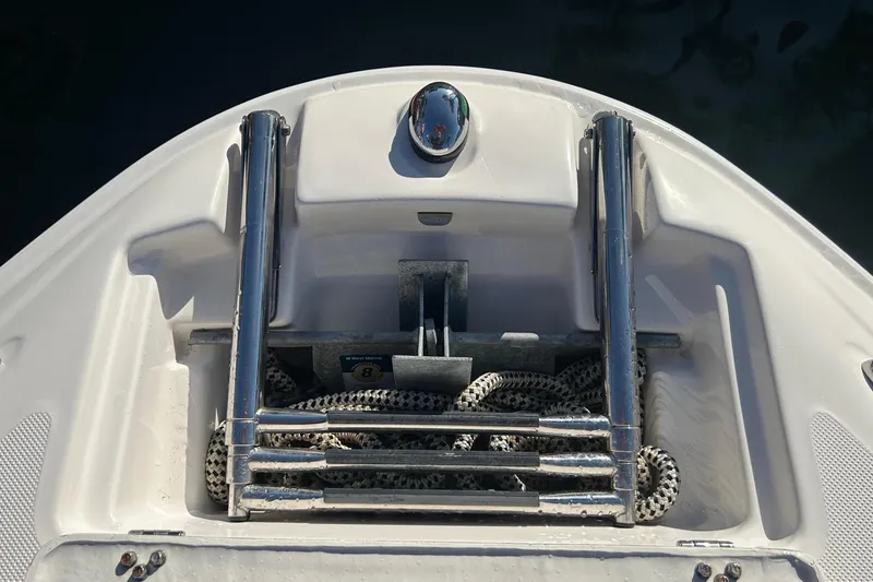 Slide: The Image of 2009 Regal 2400 Bowrider boat ladder with coiled rope on deck. - 41