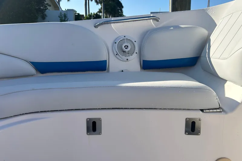 Slide: The Image of 2009 Regal 2400 Bowrider boat interior with white and blue seating and speaker. - 46
