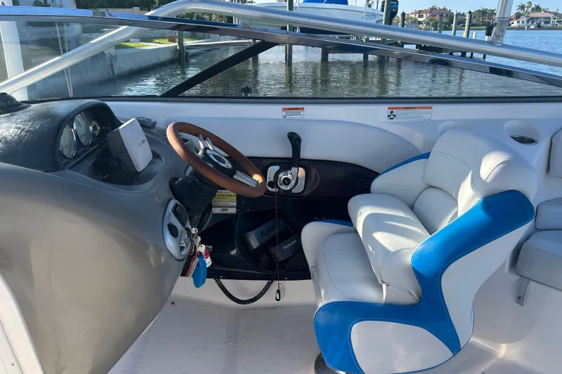 Slide: The Image of Interior of a 2009 Regal 2400 Bowrider boat with steering wheel and seating. - 20
