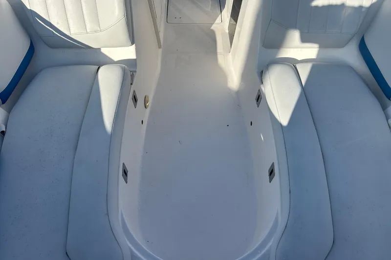 Slide: The Image of 2009 Regal 2400 Bowrider interior with white seating and blue accents. - 48