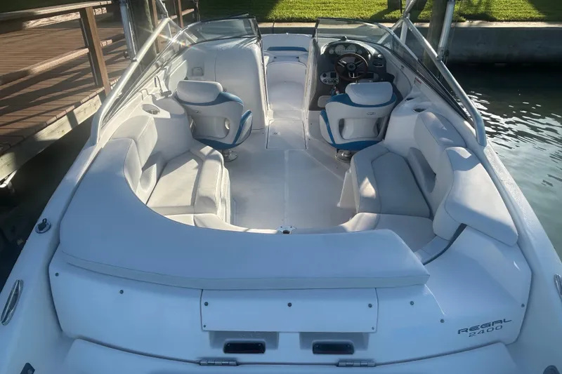 Slide: The Image of 2009 Regal 2400 Bowrider boat with spacious seating and sleek design. - 12