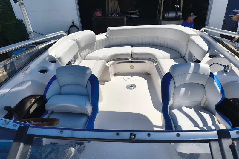 Slide: The Image of 2009 Regal 2400 Bowrider interior with white seating and blue accents, showcasing spacious design. - 2
