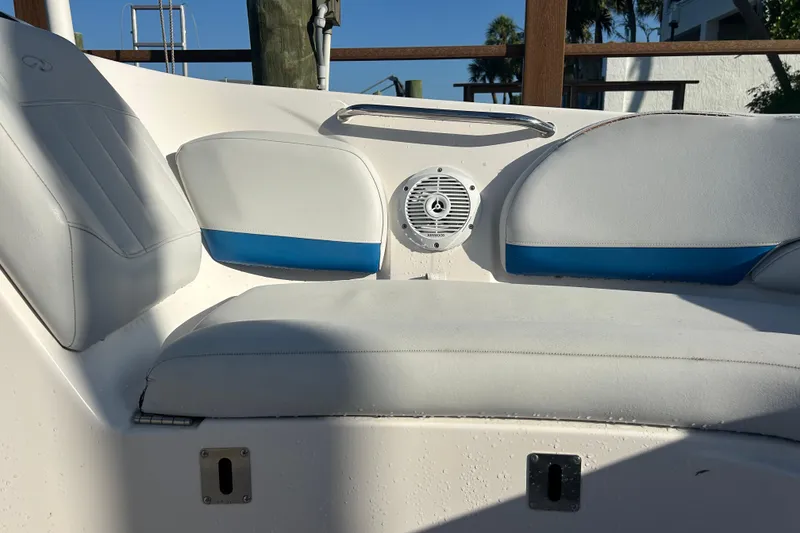 Slide: The Image of 2009 Regal 2400 Bowrider boat interior with white and blue seating and speaker. - 47