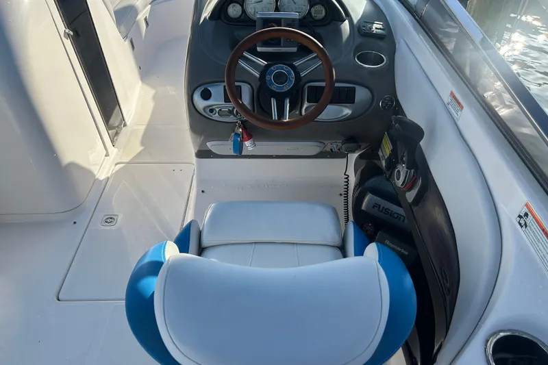 Slide: The Image of 2009 Regal 2400 Bowrider cockpit with steering wheel and control panel. - 21