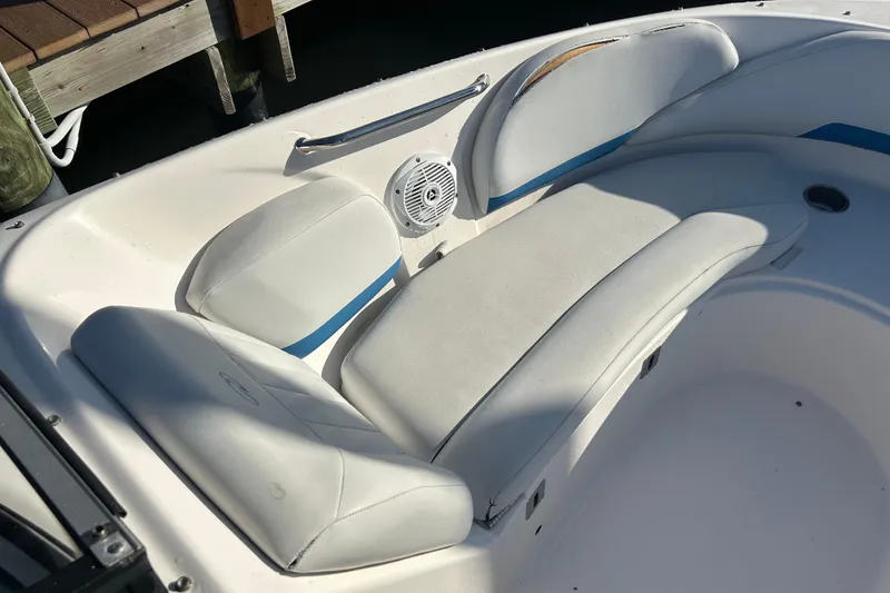 Slide: The Image of 2009 Regal 2400 Bowrider boat interior with white cushioned seating and speaker. - 44