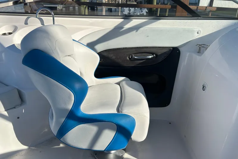 Slide: The Image of 2009 Regal 2400 Bowrider interior with blue and white seating, sleek design. - 56
