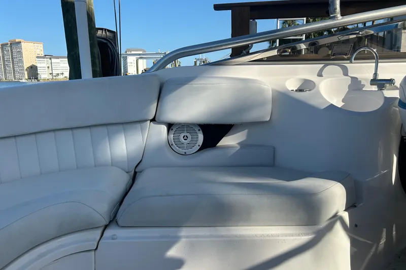 Slide: The Image of 2009 Regal 2400 Bowrider interior with white seating and built-in speaker. - 57