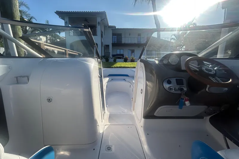 Slide: The Image of 2009 Regal 2400 Bowrider interior with steering wheel, dashboard, and sunlit view. - 34