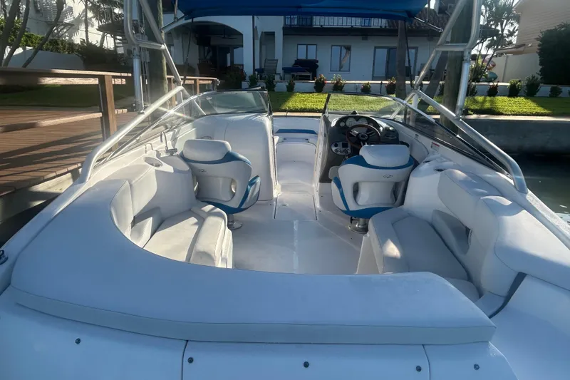 Slide: The Image of 2009 Regal 2400 Bowrider boat interior with white seating and blue accents. - 16