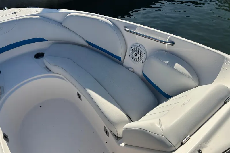 Slide: The Image of 2009 Regal 2400 Bowrider boat interior with white seating and blue accents. - 42