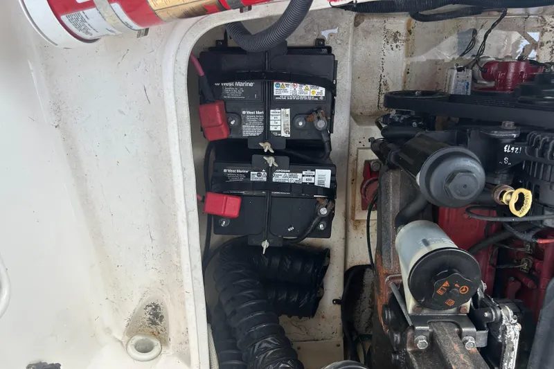 Slide: The Image of Engine compartment of a 2009 Regal 2400 Bowrider with batteries and fire extinguisher. - 66