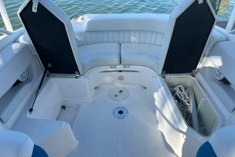 Slide: The Image of 2009 Regal 2400 Bowrider interior with white seating and storage compartments. - 63