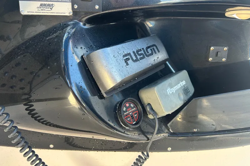 Slide: The Image of Close-up of 2009 Regal 2400 Bowrider boat electronics, featuring Fusion and Raymarine devices. - 27