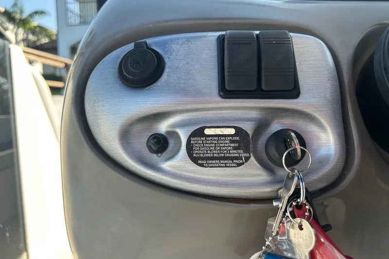 Slide: The Image of Control panel of a 2009 Regal 2400 Bowrider boat with ignition keys. - 24