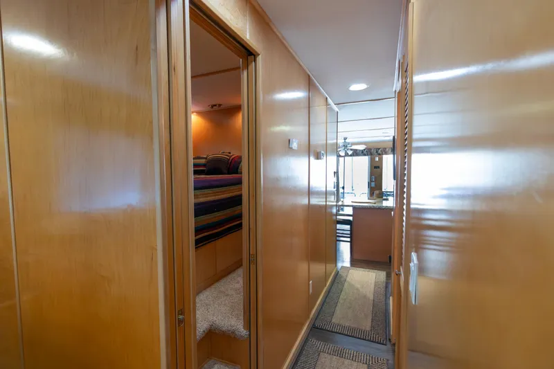 Slide: The Image of Hallway inside 2001 Stardust Cruisers Executive Aft Cabin, featuring wood paneling and cozy bedroom entrance. - 25