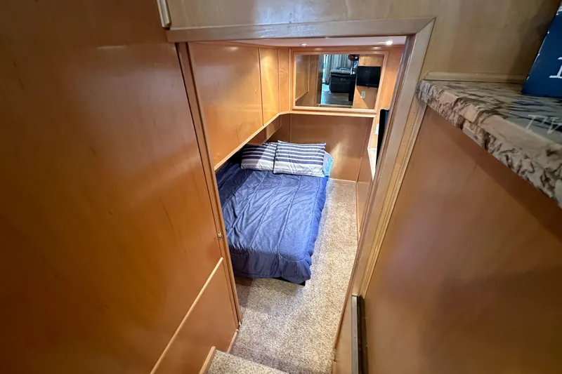 Slide: The Image of Cozy cabin interior of 2001 Stardust Cruisers Executive Aft Cabin with bed and wooden paneling. - 19