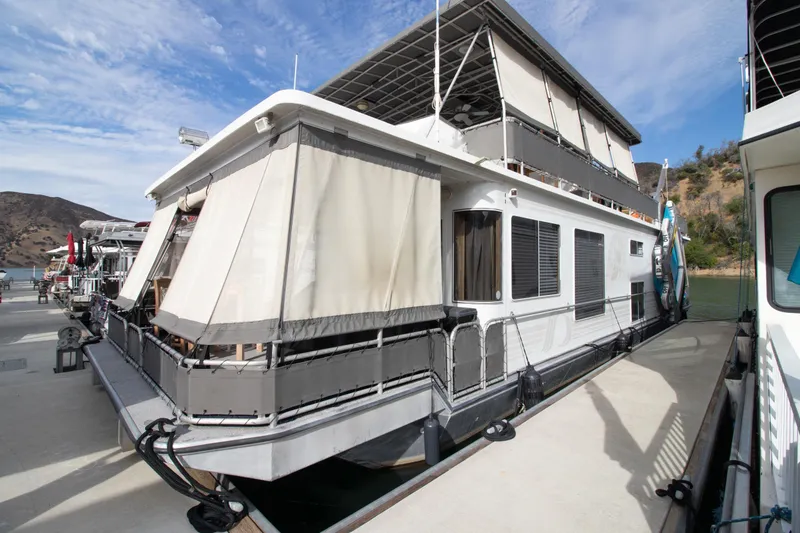 Slide: The Image of 2001 Stardust Cruisers Executive Aft Cabin houseboat docked, featuring spacious upper deck and modern design. - 67