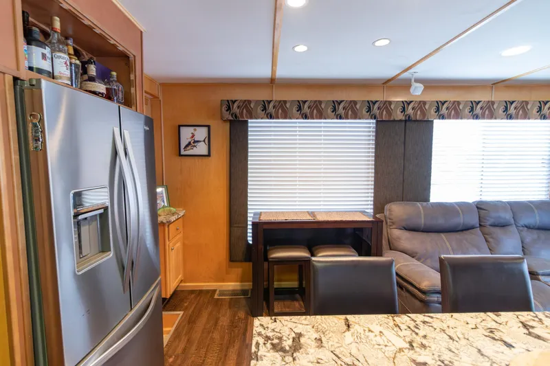 Slide: The Image of Interior of 2001 Stardust Cruisers Executive Aft Cabin with modern kitchen and seating area. - 17