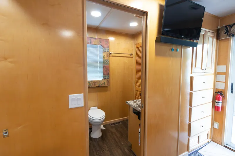 Slide: The Image of Interior of 2001 Stardust Cruisers Executive Aft Cabin with bathroom and TV. - 35