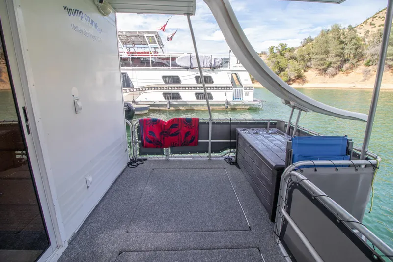Slide: The Image of Houseboat deck with slide, overlooking water and another boat; 2001 Stardust Cruisers Executive Aft Cabin. - 50