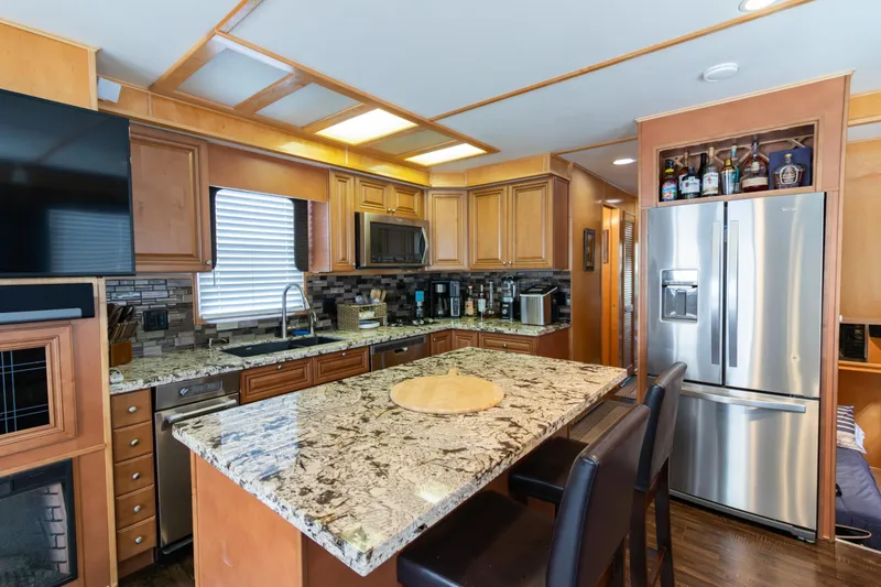 Slide: The Image of Luxurious kitchen interior of 2001 Stardust Cruisers Executive Aft Cabin with granite countertops. - 11