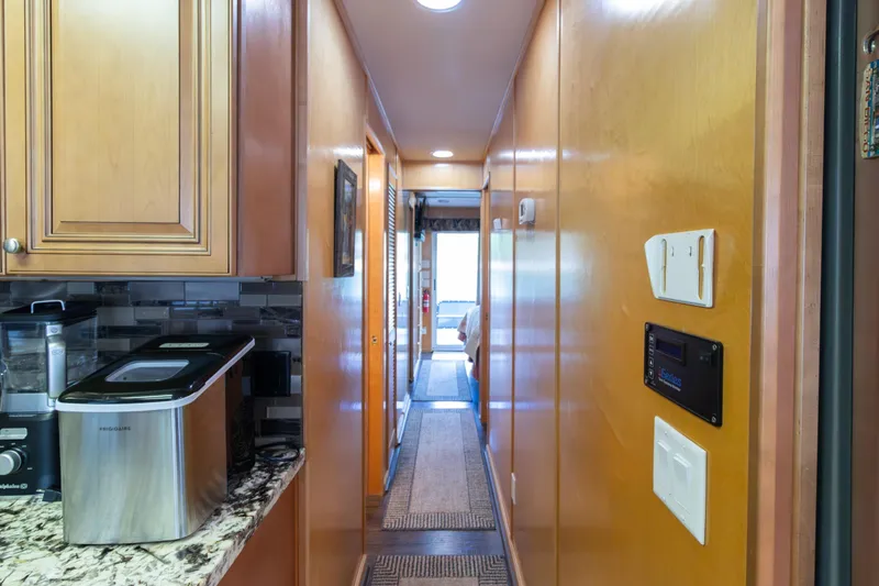 Slide: The Image of Hallway view inside 2001 Stardust Cruisers Executive Aft Cabin, featuring modern kitchen appliances. - 24